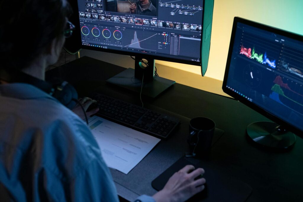 Creating bingeable content for social media in 2025 using dual monitors at a desk