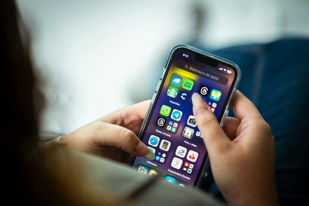 a woman looking at social media apps on her iphone
