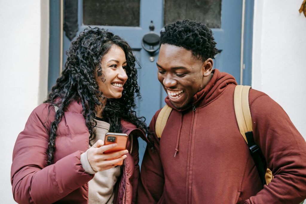 A couple laughing at a viral short video