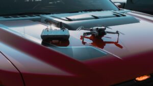 A dji mini 4 pro sitting on the hood of a ford raptor